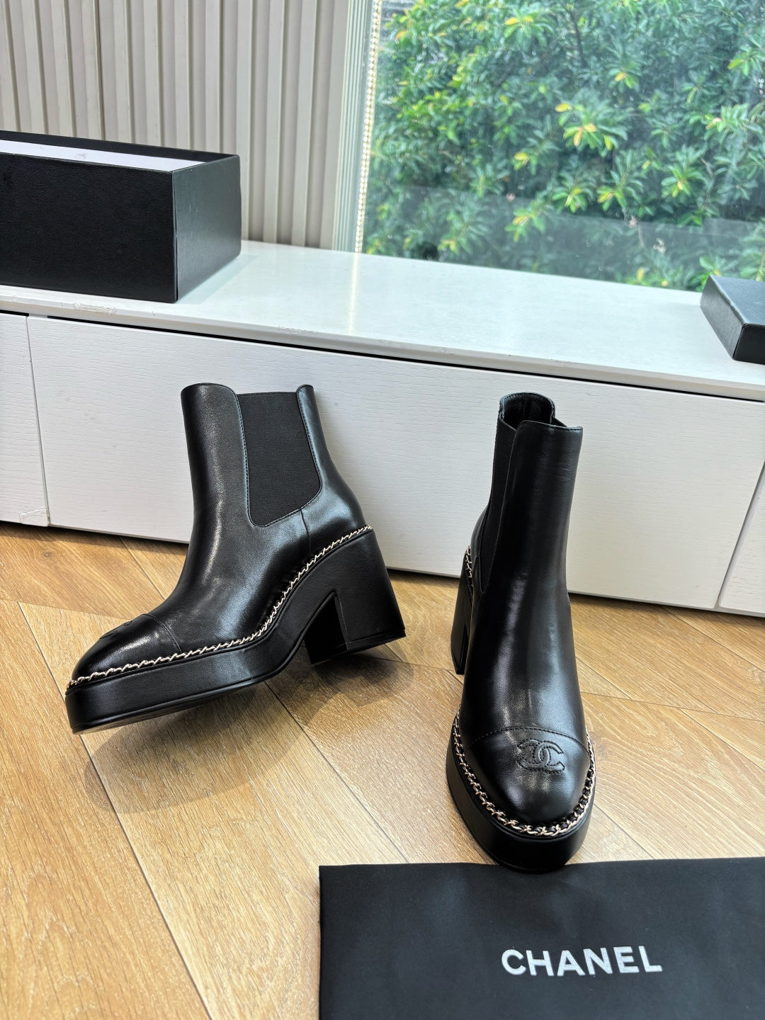Black ankle boots with stacked block heels and contrast-stitched border