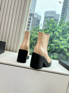 Beige leather ankle boots with elastic sides, black heel and contrast toe detail