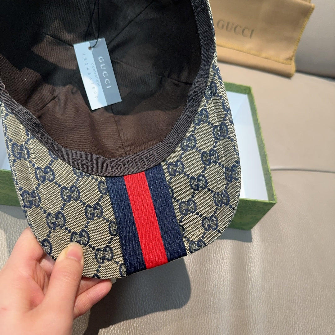 Gucci cap close-up: GG logo fabric and navy-red stripe panel on crown