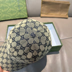 Gucci GG logo baseball cap, light background with navy allover pattern