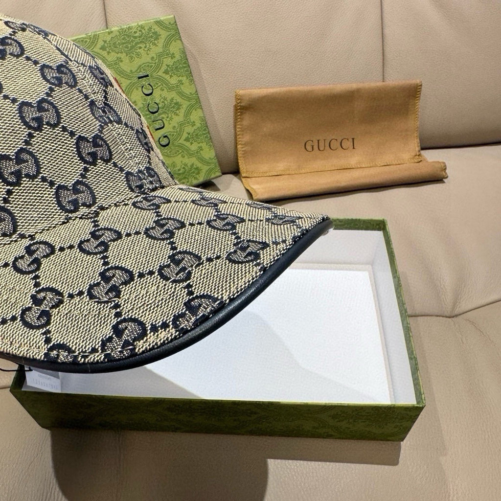 Gucci cap brim close-up with blue GG pattern and dark fabric edge