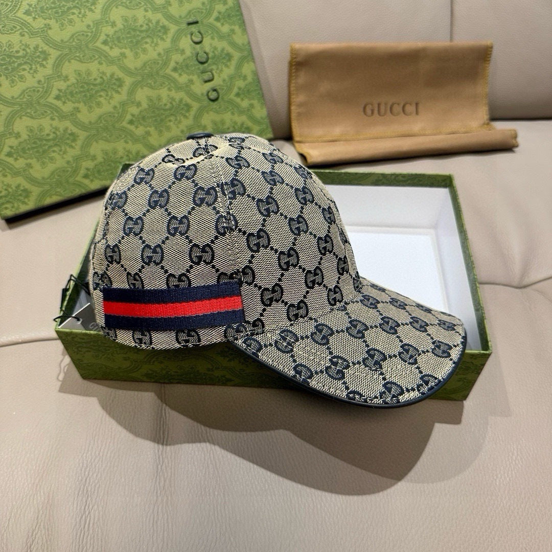 Gucci cap with blue GG print and red, navy, and green web stripe across side