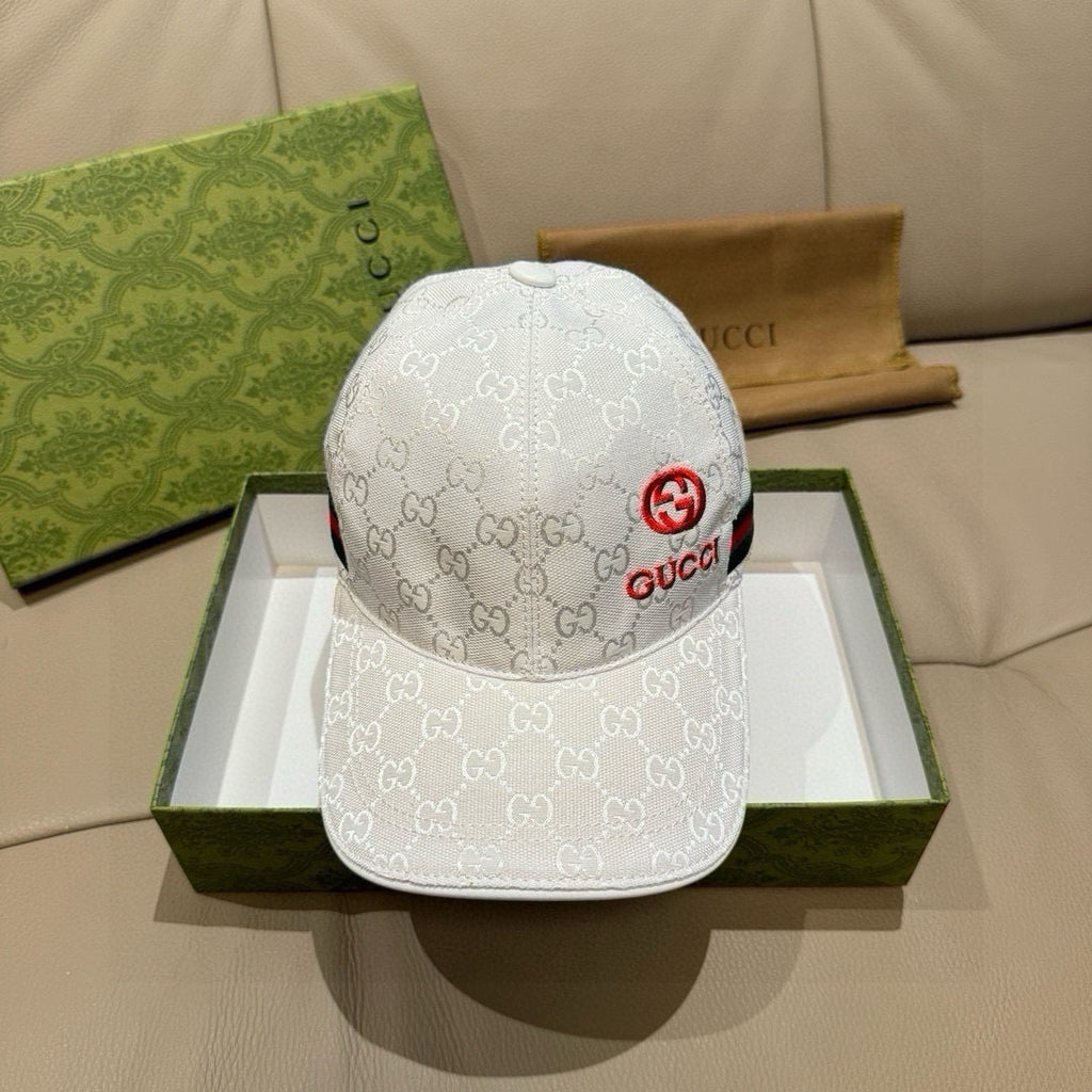 White GG-print baseball cap with red Gucci emblem on front and curved brim