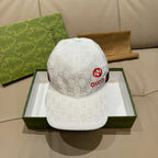 White GG-print baseball cap with red Gucci emblem on front and curved brim