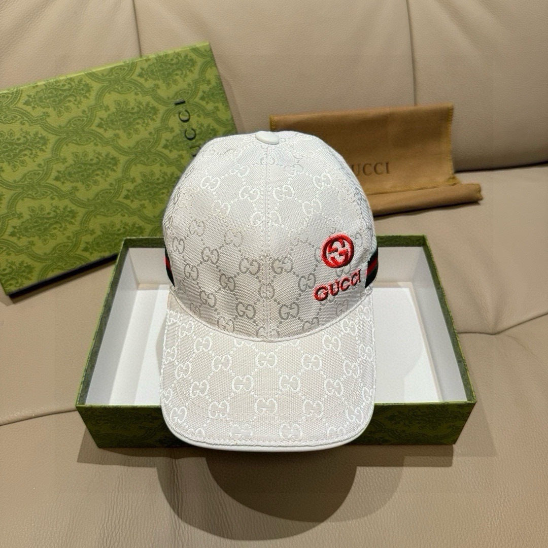 White GG-print baseball cap with red Gucci emblem on front and curved brim