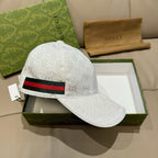 White GG-print baseball cap with black, red, and green striped web band