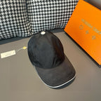 Louis Vuitton cap, dark gray with white button and curved brim, side view