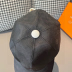 Dark gray baseball cap top with white button, textured pattern, seam detailing