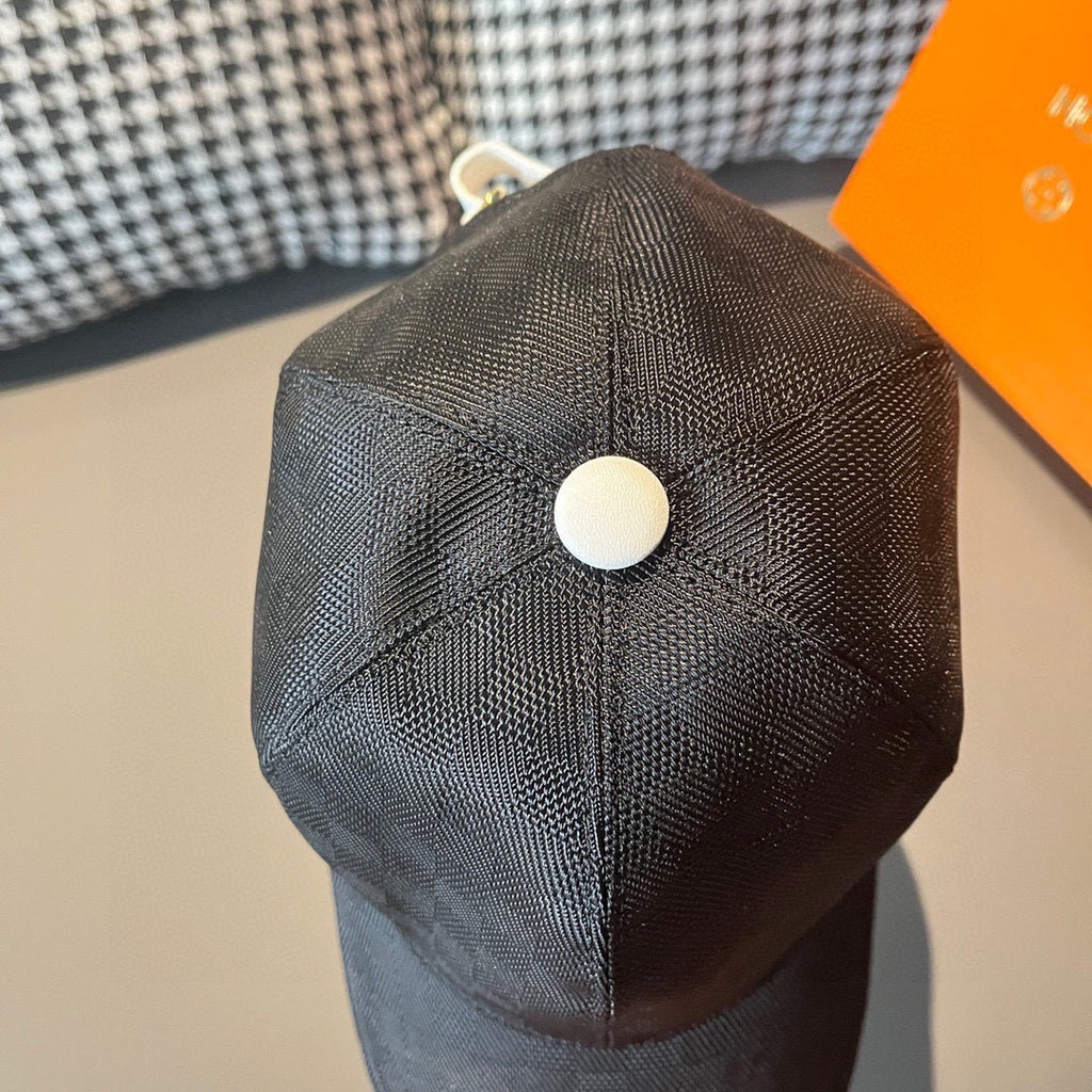 Dark baseball cap with curved brim and round white top button