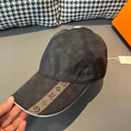 Louis Vuitton patterned dark cap with white button and matching visor.