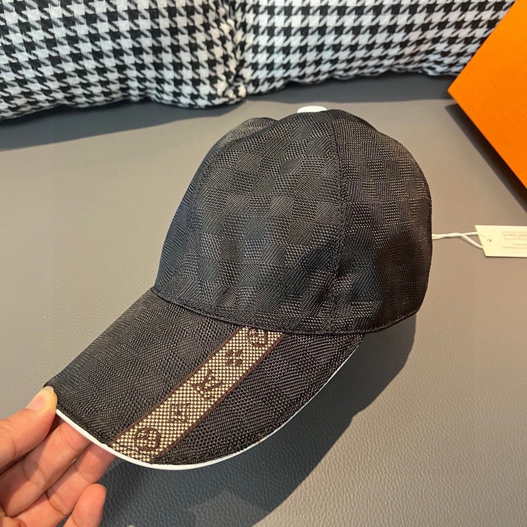 Louis Vuitton patterned dark cap with white button and matching visor.