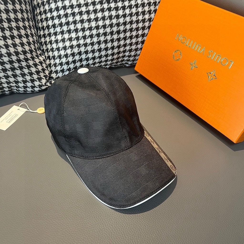 Louis Vuitton dark cap with white top button and textured curved visor.