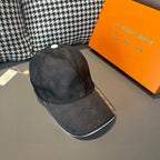 Louis Vuitton dark cap with white top button and textured curved visor.
