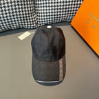 Louis Vuitton dark cap with white top button and textured brim.