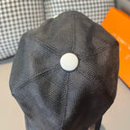 Louis Vuitton dark cap with white top button and stitched crown.