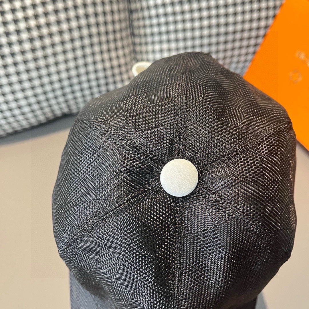 Baseball cap, dark textured crown, white round button at back