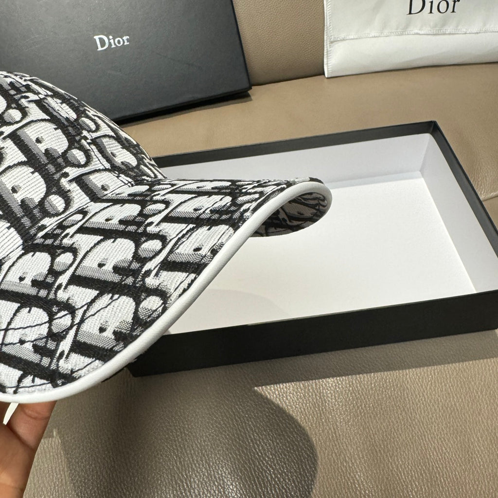 Dior cap side view showing curved brim edge in black-and-white monogram print