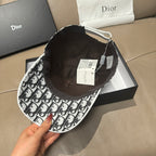 Dior baseball cap interior view, black lining, adjustable strap and hanging tags.