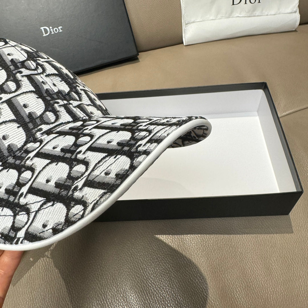 Dior baseball cap brim close-up, black-and-white Dior pattern fabric.