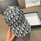 Dior baseball cap close-up, black-and-white Dior pattern, round button on top.