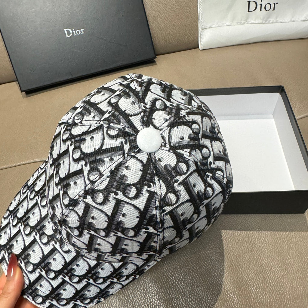 Dior baseball cap top view, black-and-white Dior logo pattern, round top button.