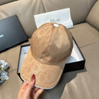 Beige monogram cap held by hand, curved brim and adjustable strap with snap