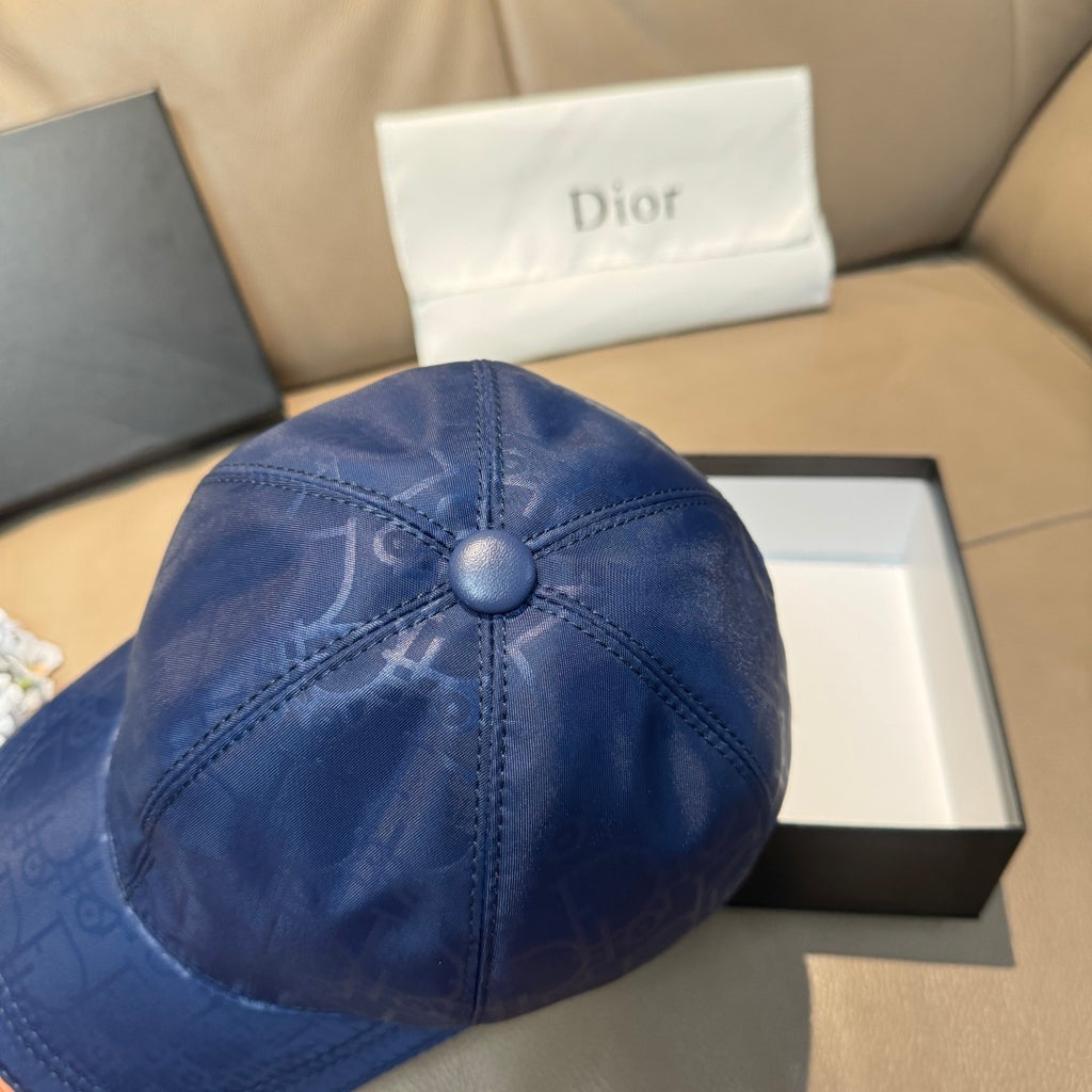 Blue monogram baseball cap, close-up of domed crown and center button