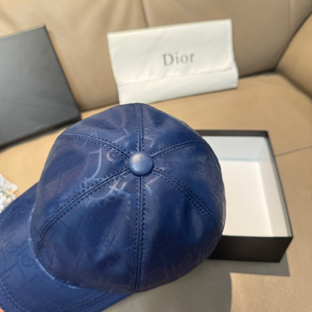 Blue monogram baseball cap, close-up of domed crown and center button