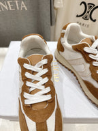 Brown and white sneakers with white laces, close-up on display box