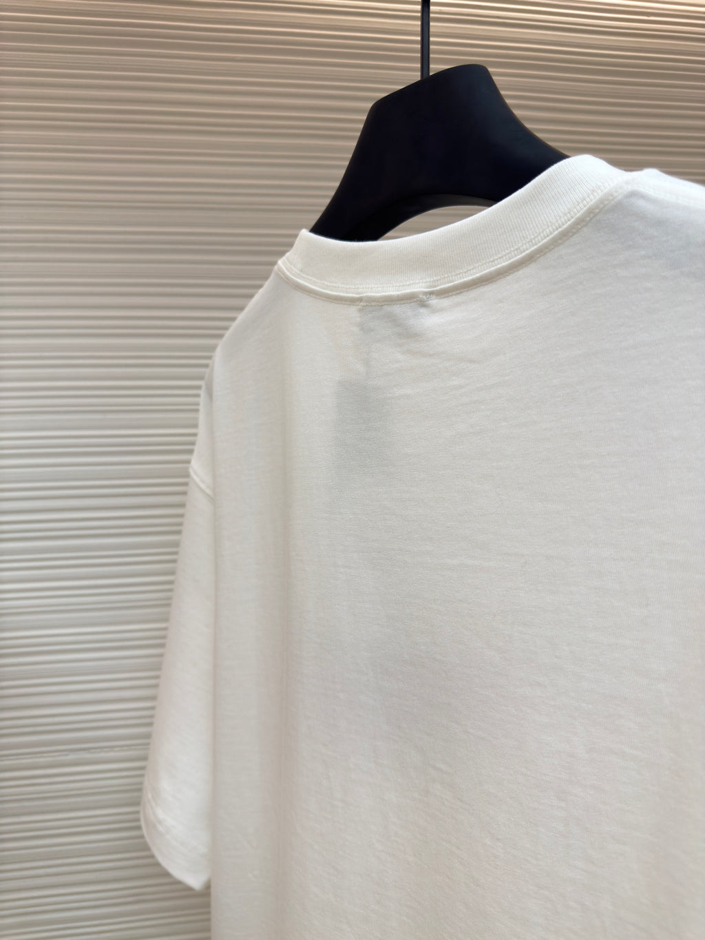 White short-sleeve T-shirt on hanger, plain back