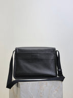 Black textured-leather crossbody bag with front flap and side strap loops