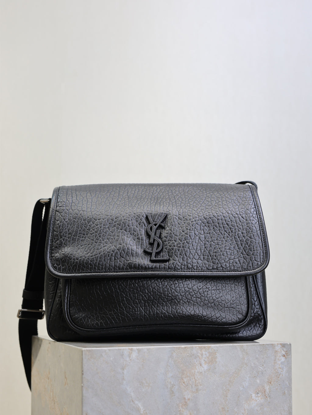 Black textured-leather crossbody bag with front flap and YSL logo emblem