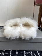 Balenciaga white faux-fur slide sandals, top view with bow logo strap detail