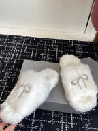 Balenciaga white faux-fur slide sandals with silver-tone logo bow on straps