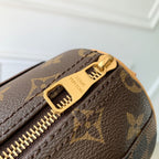 Designer monogram handbag close-up of zipper pull and gold hardware