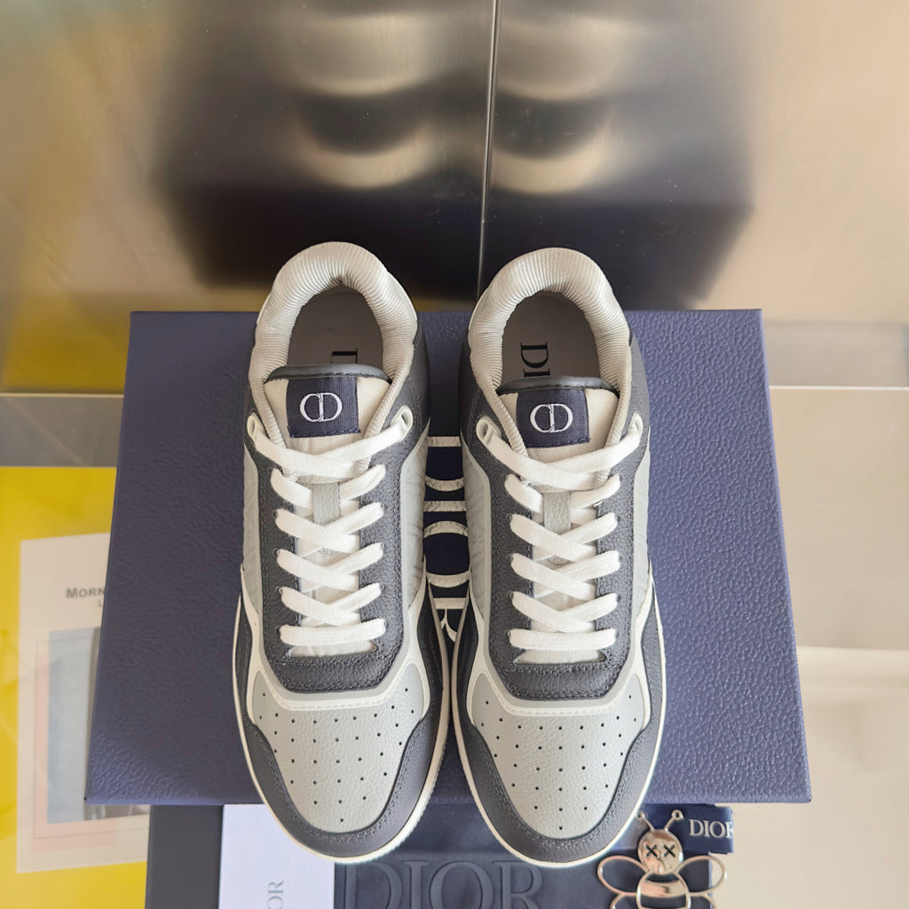 Pair of low-top Dior sneakers in dark blue and white, lace-up with logo tongue tabs