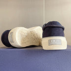 Unisex sneakers heel view with dark blue upper and patterned white rubber outsole