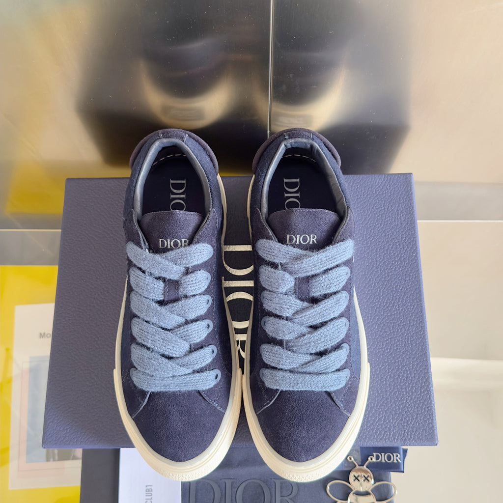Unisex sneakers dark blue suede with light blue laces and white rubber soles, front view