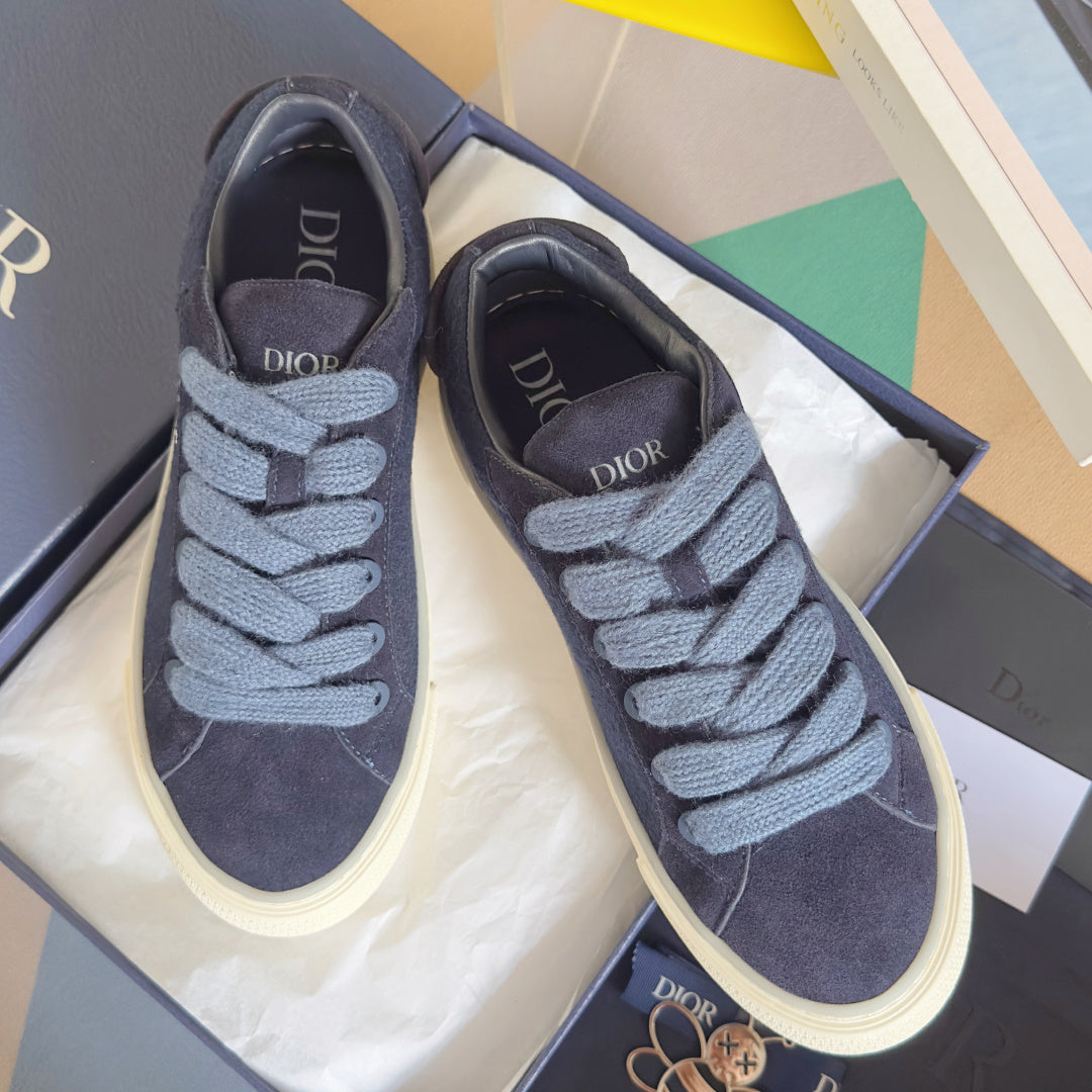 Unisex sneakers pair, dark blue suede with light blue laces and white midsoles