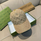 Beige GG monogram baseball cap with curved brim and stitched side panel seam.