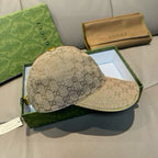 Beige GG monogram baseball cap with curved brim and dark underbrim stitching.