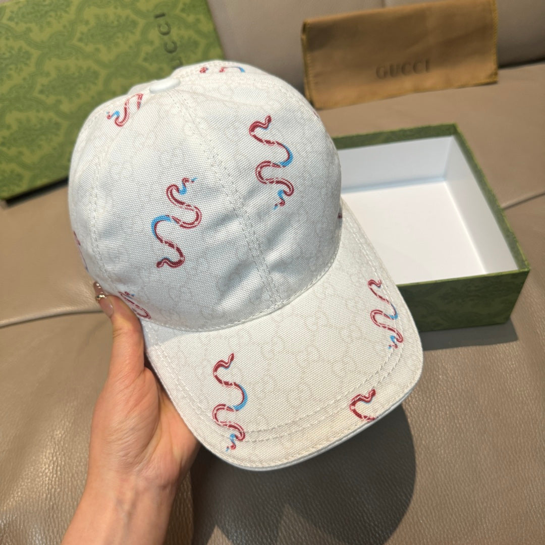 Gucci white canvas cap with red and blue snake embroidery, hand-held angle