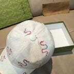 Gucci white canvas cap with red and blue snake embroidery, metal button back