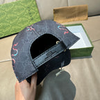 Gucci baseball cap side view with dark denim strap and embroidered red/blue motif