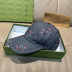 Gucci baseball cap in dark denim with red and blue swirl embroidery