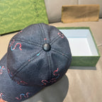 Gucci baseball cap close-up with dark denim crown and embroidered red and blue motif