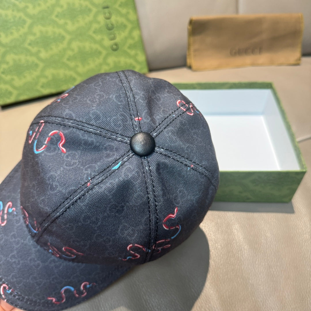 Gucci baseball cap close-up with dark denim crown and embroidered red and blue motif
