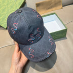 Gucci baseball cap in dark denim with red and blue embroidered swirls