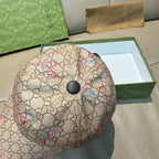 Beige Gucci baseball cap with GG-style monogram print and multicolor snake details