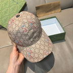 Beige Gucci baseball cap, front three-quarter view with multicolor snake print